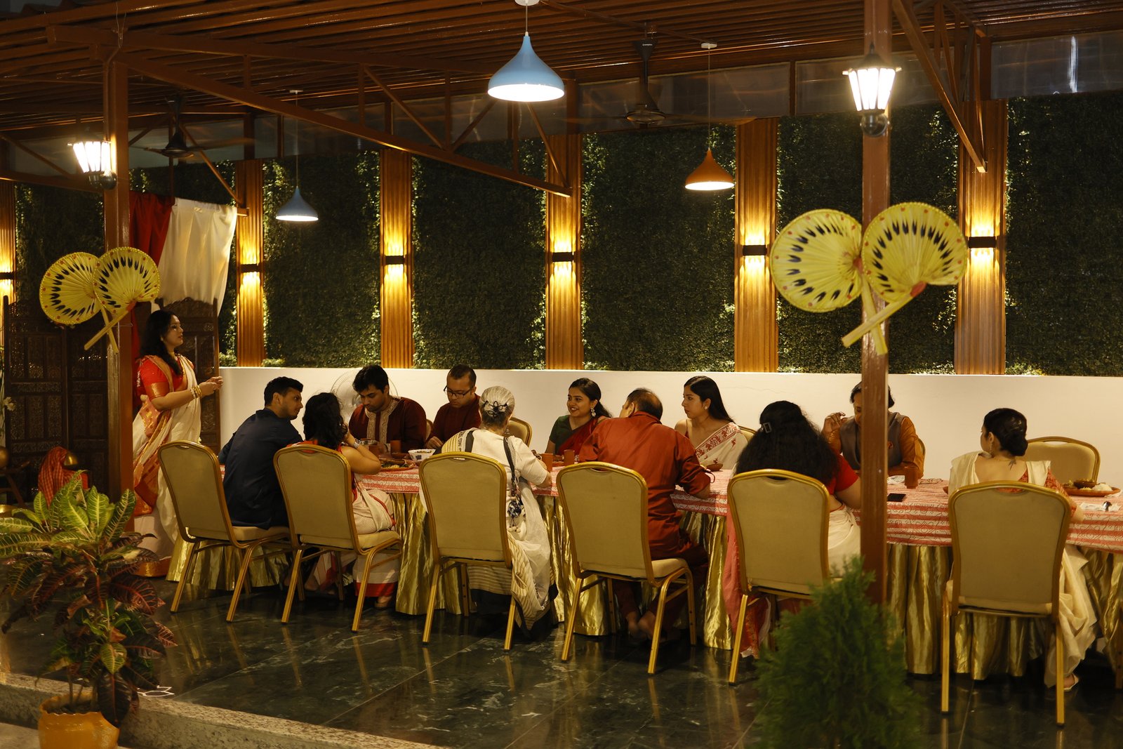 A gathering at Kalpana — guests around the long table on a warm evening